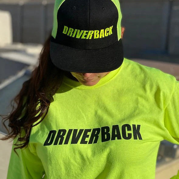 Woman wearing high-vis driverback shirt and hat